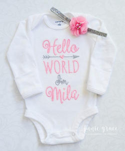 full view of baby girl romper embroidered in pink with Hello World I'm Mila!