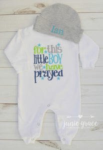 Full view of baby boy romper embroidered with For this little boy we have prayed and personalized hat which reads Ian