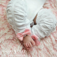 White scrunch leggings with pink bows on baby girl
