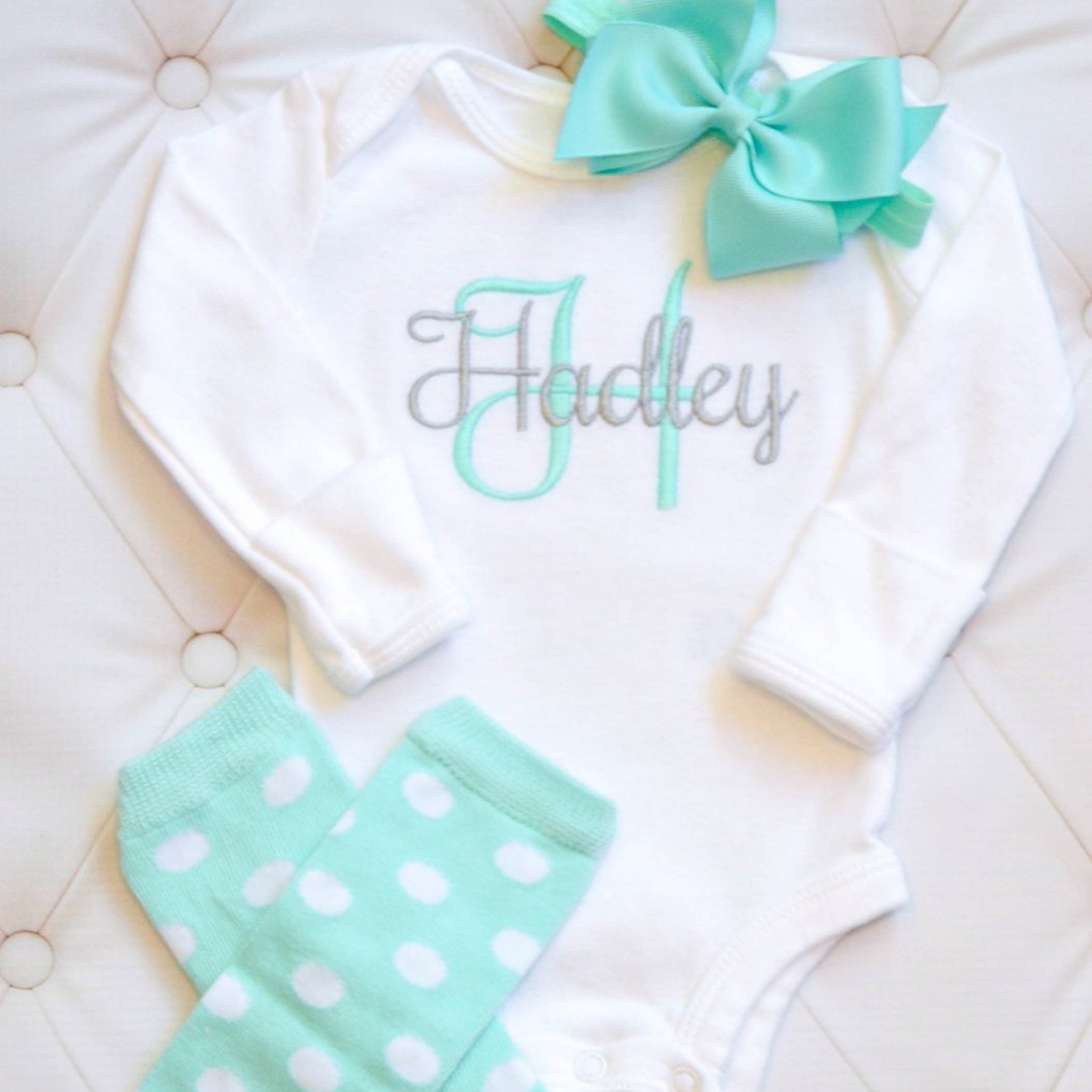 cute teal colored leg warmers and matching headband with personalized embroidered baby bodysuit with the name Hadley