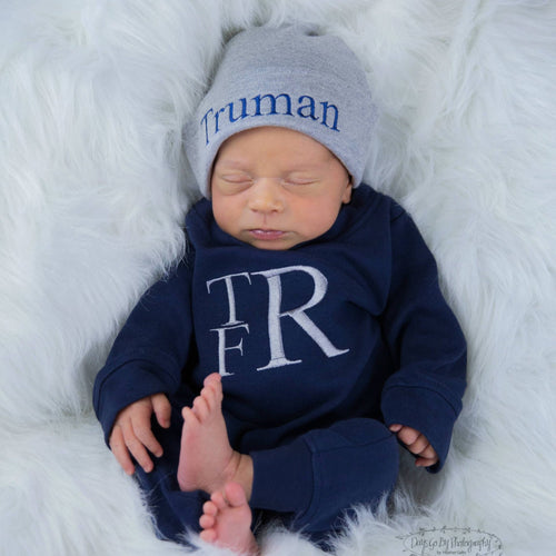 Baby boy Truman wearing his monogrammed and personalized navy blue and grey matching romper and hat set