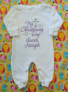 Full view of baby girl romper embroidered in lilac with "My Christening Day"